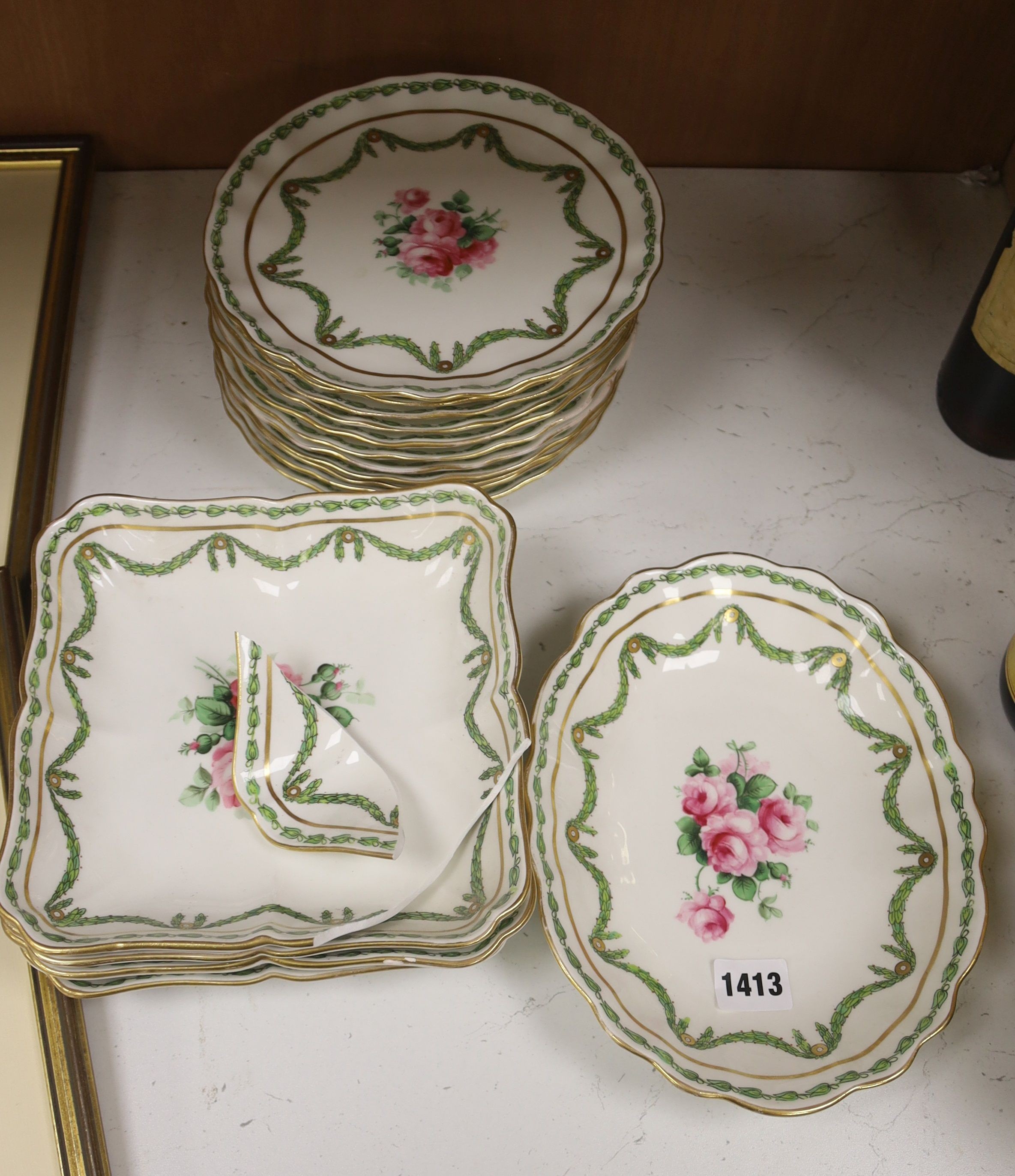 A quantity of 19th century hand painted floral plates, decorated with roses set within trailing garlands, marked T. Goode & Co, London